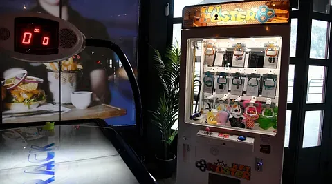 Hvit luft-hockeymaskin og klyomaskin i belyst innendørsområde.